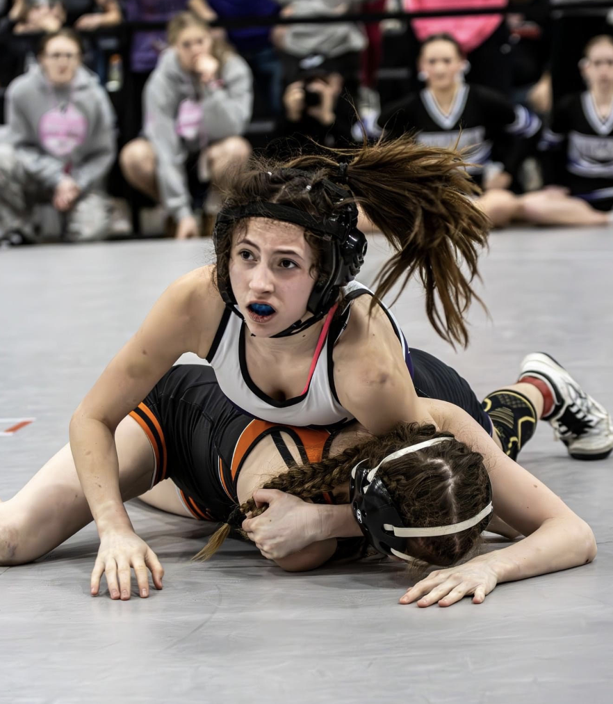 Madison wrestles opponent at state qualifying meet. 